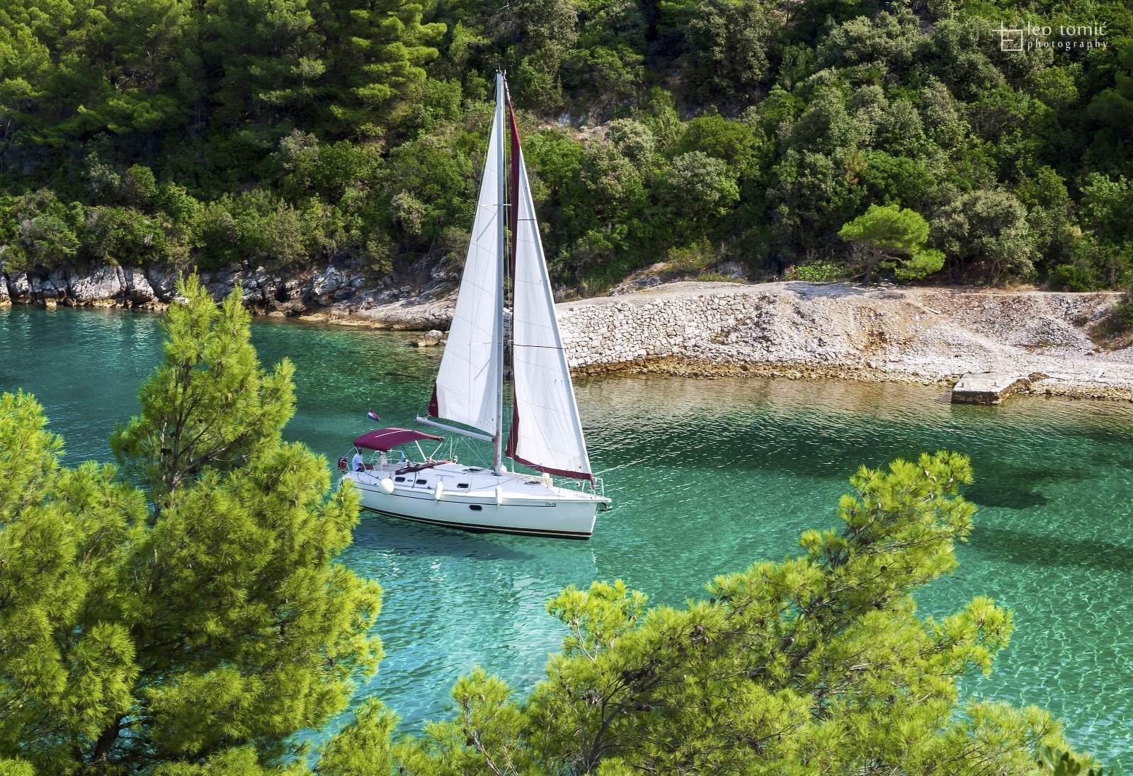 Crystal-clear Adriatic waters at a secluded bay near Brač Island, Croatia